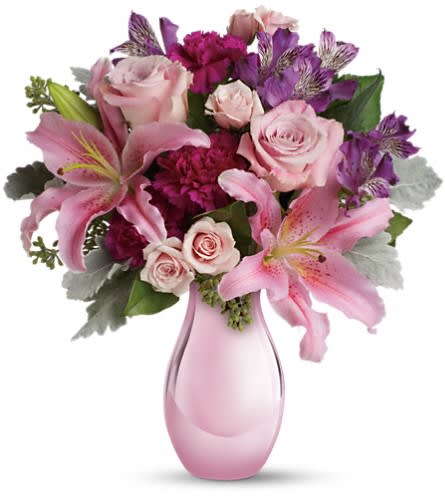Enchanting Pinks by Teleflora Enchanting Pinks by Teleflora - Imagine her joy when she opens the door and sees this incredible array of roses lilies and other favorites in an elegant pink reflections vase. She'll be talking about it for weeks. The exquisite bouquet includes pink roses light pink spray roses light pink oriental lilies purple alstroemeria and fuchsia carnations accented with assorted greenery. Delivered in Teleflora's exclusive pink reflections vase.Approximately 16" W x 17 1/2" H Orientation: One-Sided As Shown : T08M150ADeluxe : T08M150BPremium : T08M150C