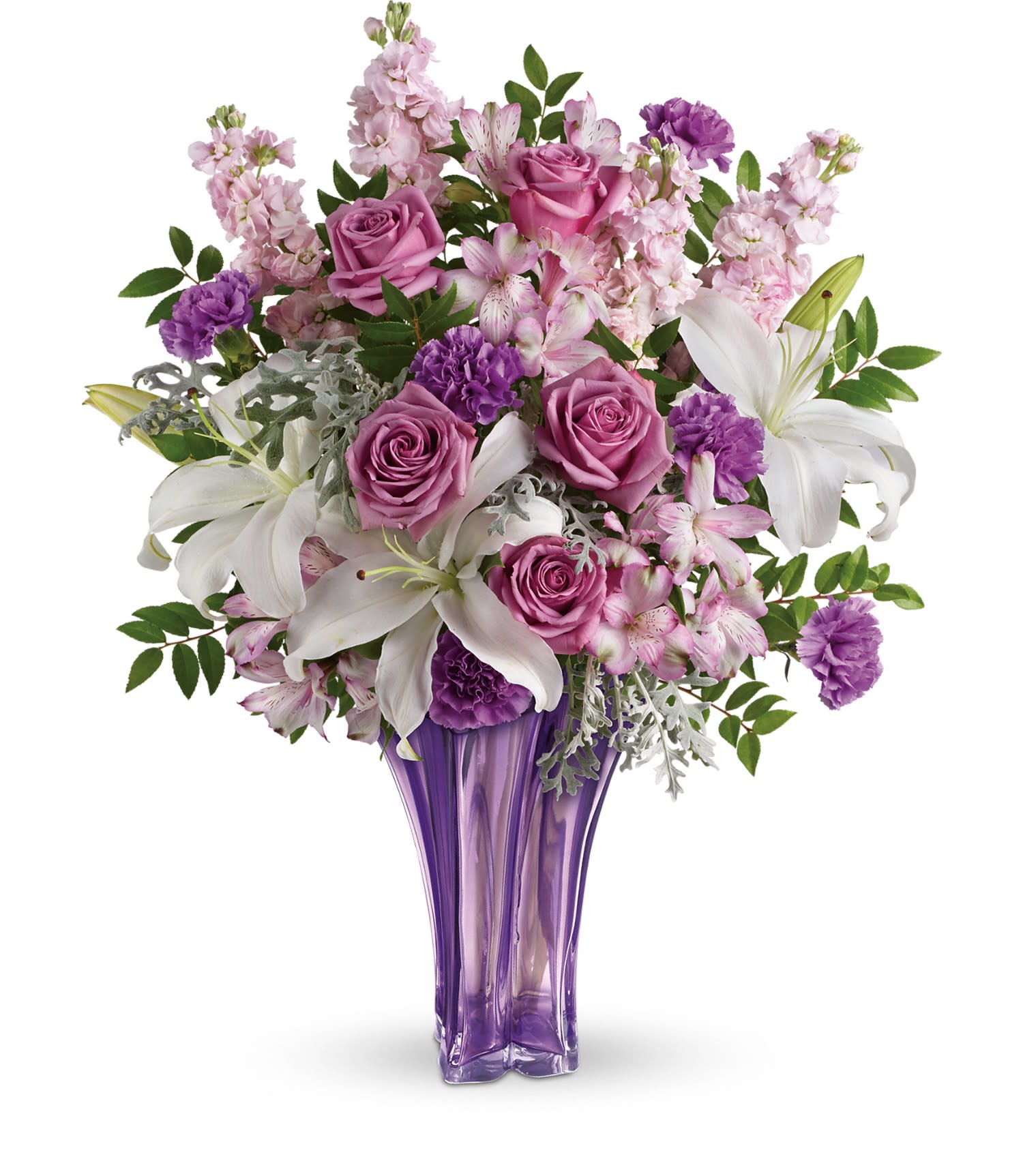 Lavished in Lilies Bouquet - Luxe lavender roses, white oriental lilies, light pink alstroemeria, lavender carnations and light pink stock are artistically arranged with huckleberry and dusty miller. Delivered in a Luxurious Lavender vase. Approximately 21 W x 25 1/2 H  T601-5A