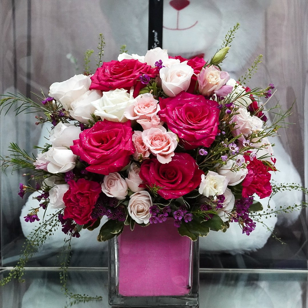 Pink Bouquet  - Hot pink Roses , pink spray roses , pink lisianthus , wax  arranged in a cube clear vase 5x5