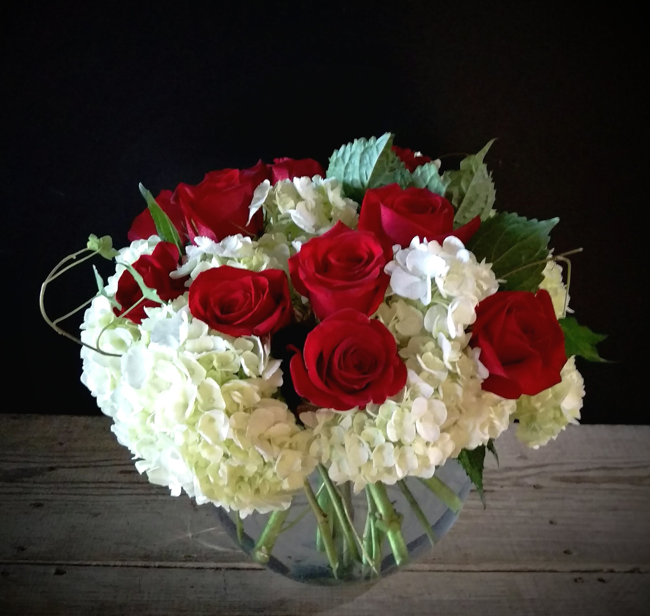  Our Love Eternal - The Our Love Eternal Bouquet is a symbol of unending love and affection.. Brilliant red roses  pop against a bed of white hydrangea simply accented with stems of  ivy and beautifully arranged in a clear glass vessel to create a wonderful way to convey your deepest sentiments.
