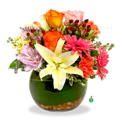 Thinking of You - Show someone you’re thinking of them with a charming presentation – this mix of pretty blossoms in a blend of warm-weather colors, tucked into a bowl lined with leaves and river rocks. A truly considerate gift.