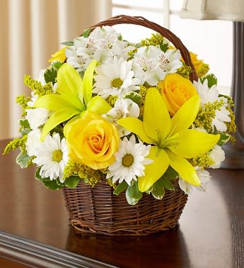 Peace, Prayers, &amp; Blessings- Yellow and White - Send a touching gesture of peace and comfort to the home or service with our beautiful arrangement of roses, lilies, alstroemeria, daisy poms and mini carnations. Elegantly arranged in a handled willow basket, it's a lovely tribute to a loved one who has passed away. Graceful yellow and white arrangement of roses, lilies, alstroemeria, daisy poms, mini carnations and solidago, accented with variegated pittosporum and myrtle Hand-arranged in a willow handled basket; measures 8&quot;H Appropriate to send to the home of friends and family members or to the memorial service   Premium arrangement measures approximately 12&quot;H x 12&quot;L  Standard arrangement measures approximately 10&quot;H X 10&quot;L   Our florists hand-design each arrangement, so colors, varieties, and basket may vary due to local availability days