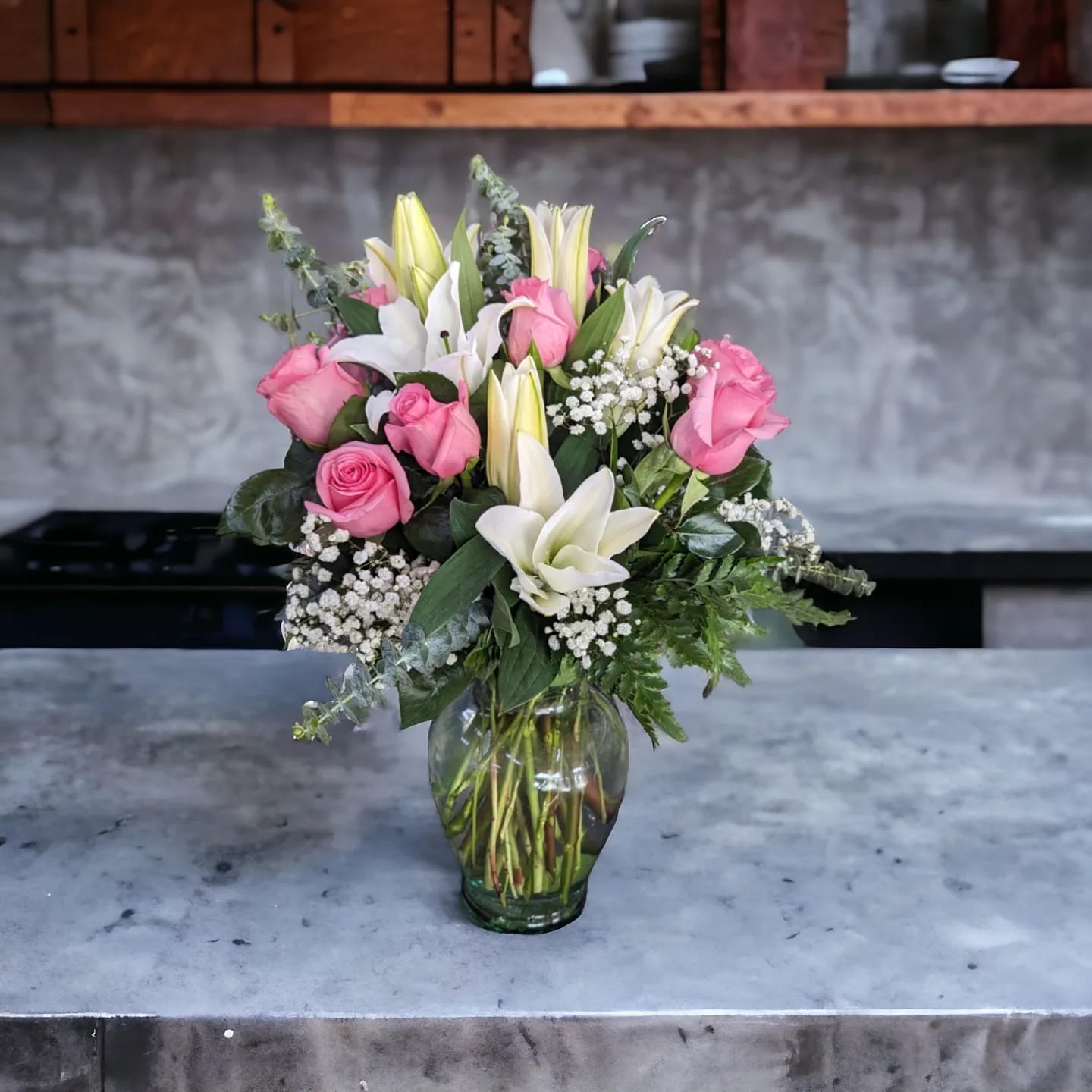 Enchanted by Parisian Florist - Dozen beautiful pink roses with six white fragrant lilies and an accent of babies breath.  If you would prefer red roses let us know in special instructions.