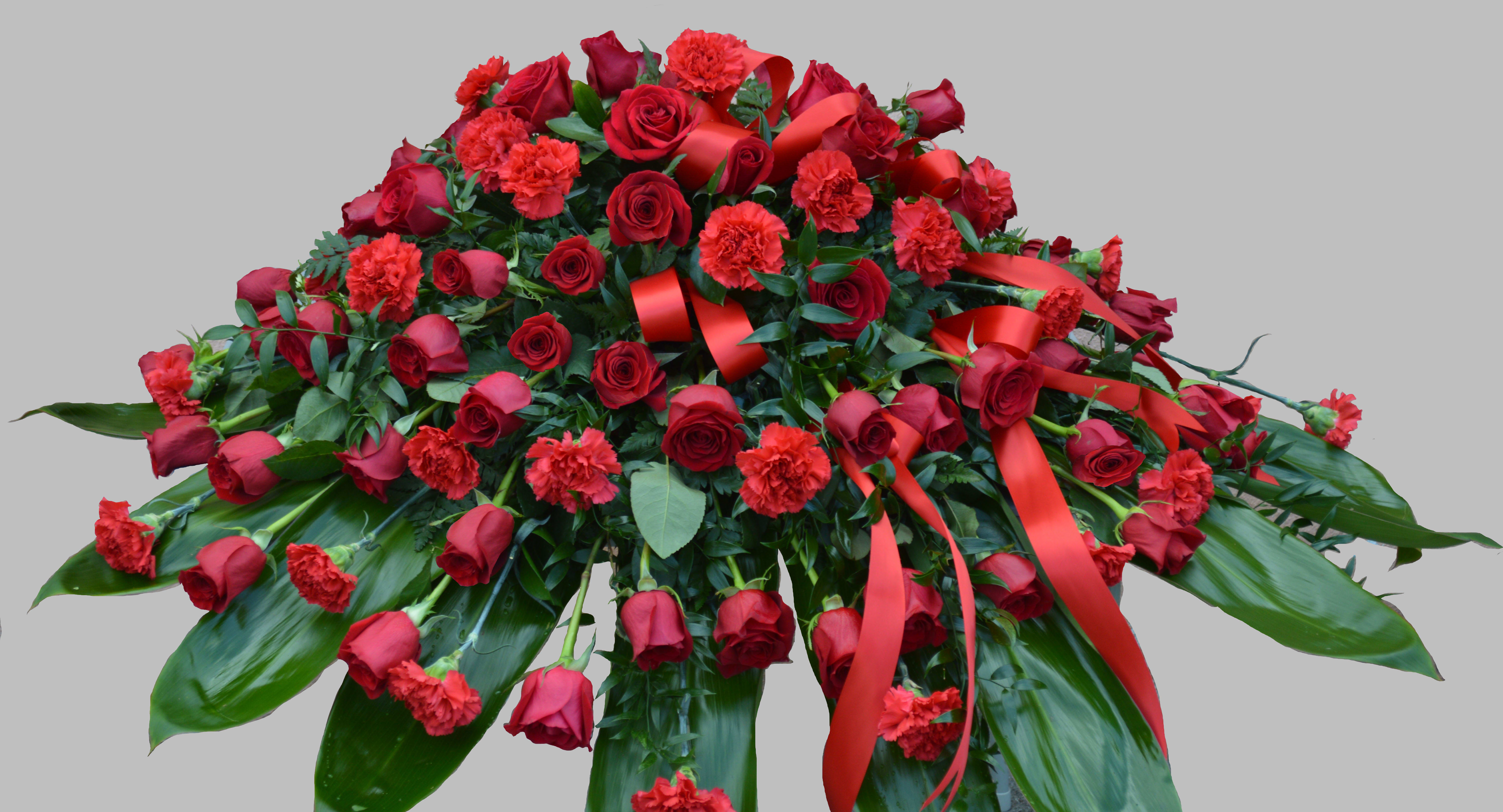 1015.CKG          Red Casket Spray  - Red carnations, Red roses AS  SIMILAR AS POSSIBLE Substitution based on season, flowers availability or any unforeseen or uncontrollable circumstances 
