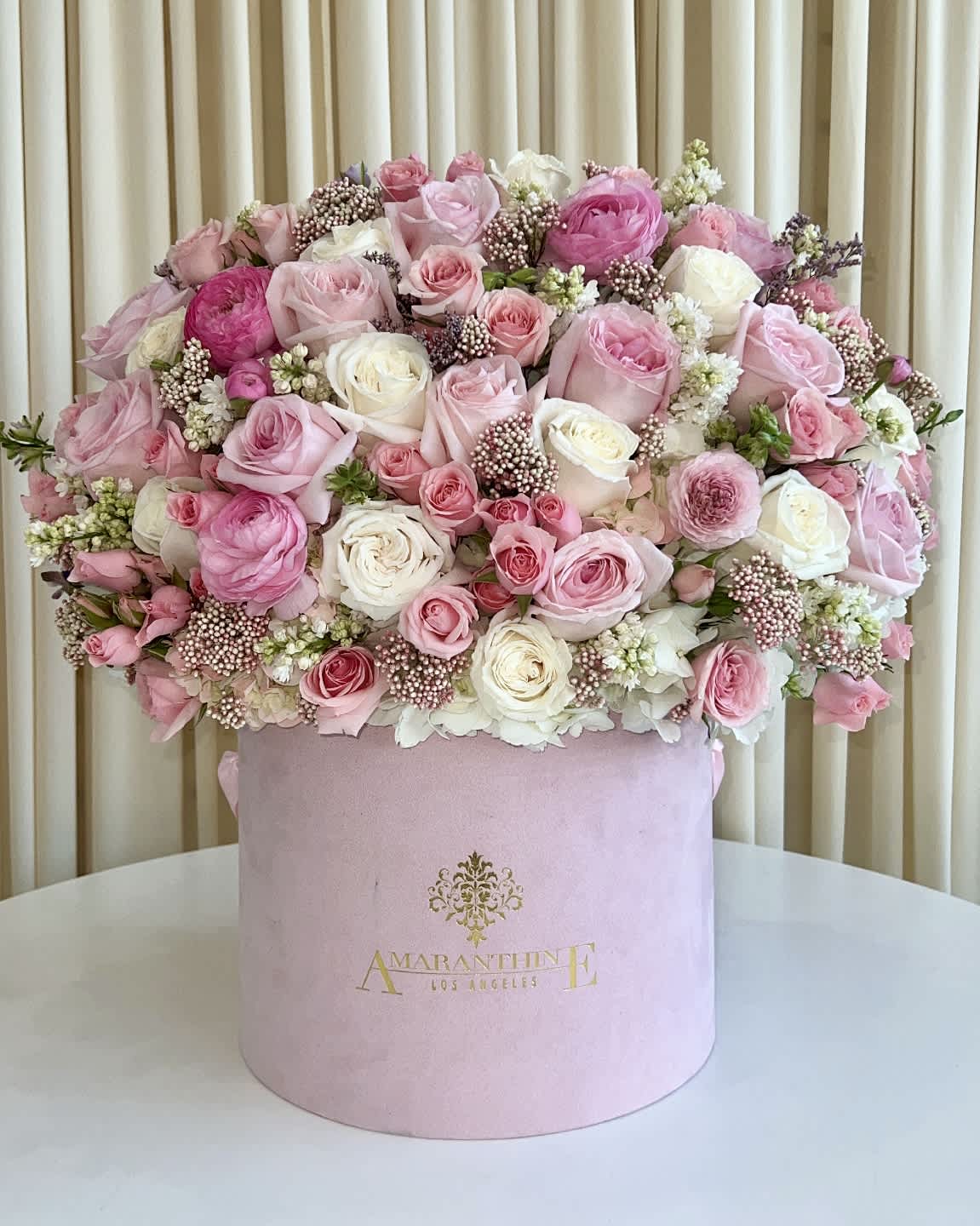 Pretty in Pink - Embrace the epitome of elegance with our &quot;Pretty in Pink&quot; Velvet Box – a mesmerizing flower arrangement showcasing a harmonious blend of soft pinks and pure whites. Delicate blooms are lovingly curated and presented in a luxurious pink velvet box, creating a sight that will steal hearts and leave a lasting impression. Whether it's a gesture of love, appreciation, or celebration, &quot;Pretty in Pink&quot; is the perfect choice to add a touch of sophistication and charm to any special moment. 