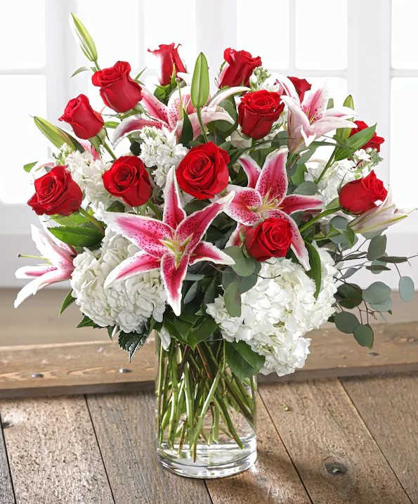 Your All That Your All That - She will love our combination premium Ecuadorian Red Mountain Roses including full-bloom garden hydrangea and fragrant stargazer lilies bursting from a chic glass vase.