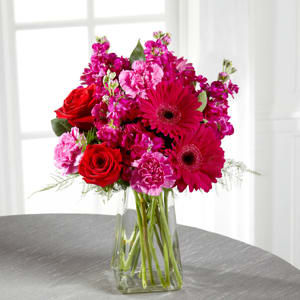Blushes of Pink Bouquet - The power of pink is packed into one beautifully blushing bouquet to make your recipient's day one they will never forget! Red roses make the hot pink petals of carnations fuchsia double bloom stock and gerbera daisies pop in this fun and fanciful flower arrangement accented with lush greens and presented in a gathered square clear glass vase. Berried happiness in every way this bouquet is set to create a standout birthday congratulations or thank you gift. GOOD bouquet includes 11 stems. Approx. 15&quot;H x 9&quot;W. BETTER bouquet includes 15 stems. Approx. 15&quot;H x 10&quot;W. BEST bouquet includes 19 stems. Approx. 16&quot;H x 14&quot;W.