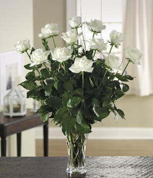 12 White Rose Bouquet arrangement - The beauty of 12 white roses is unchallenged. Representing innocence, their versatility makes them a favorite gift to offer congratulations for graduation, engagements, bridal showers, new baby