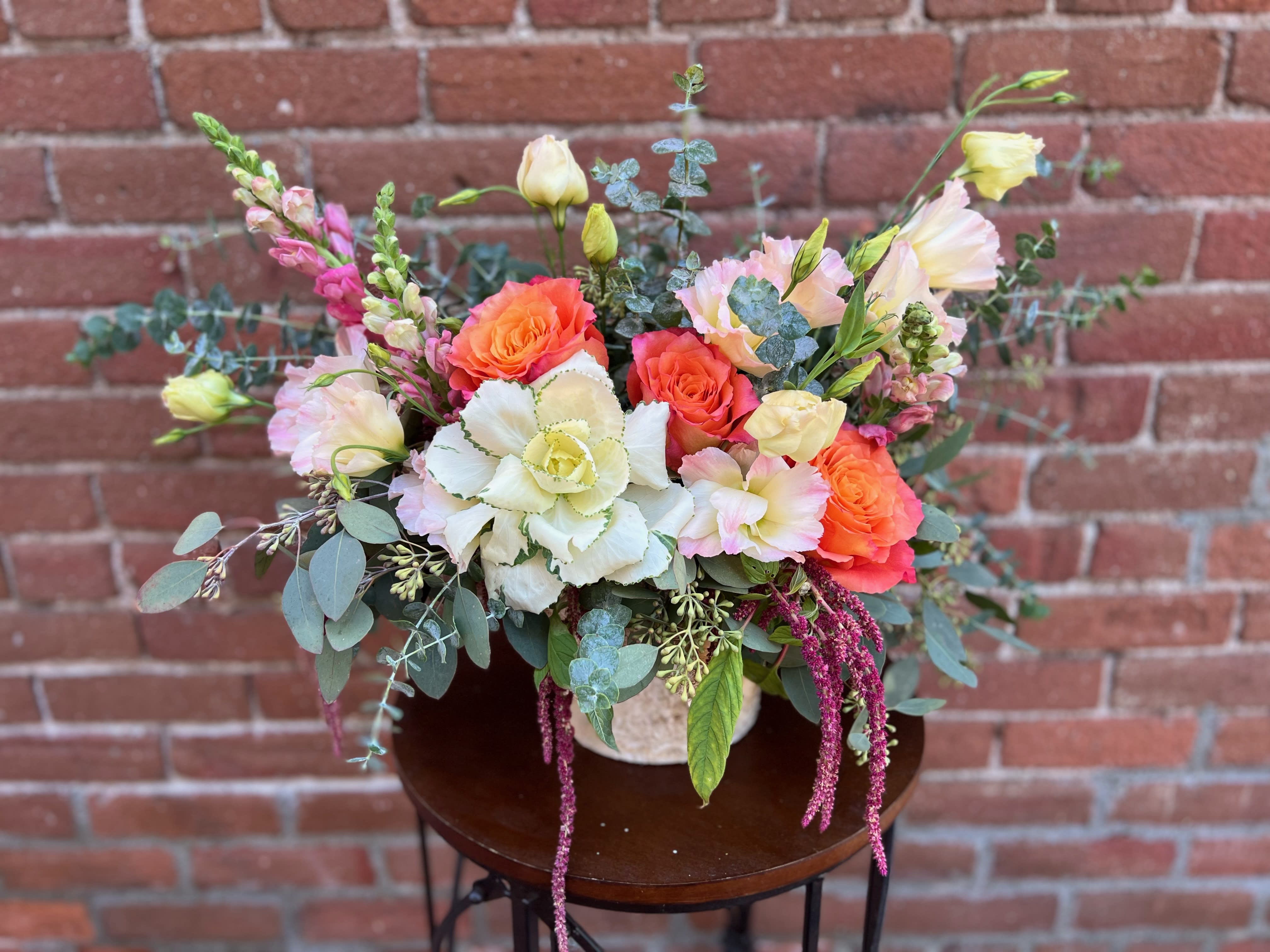 Falling for you Falling for you - a lovely selection of kale orange roses snap dragons and lissianthus with fall greens