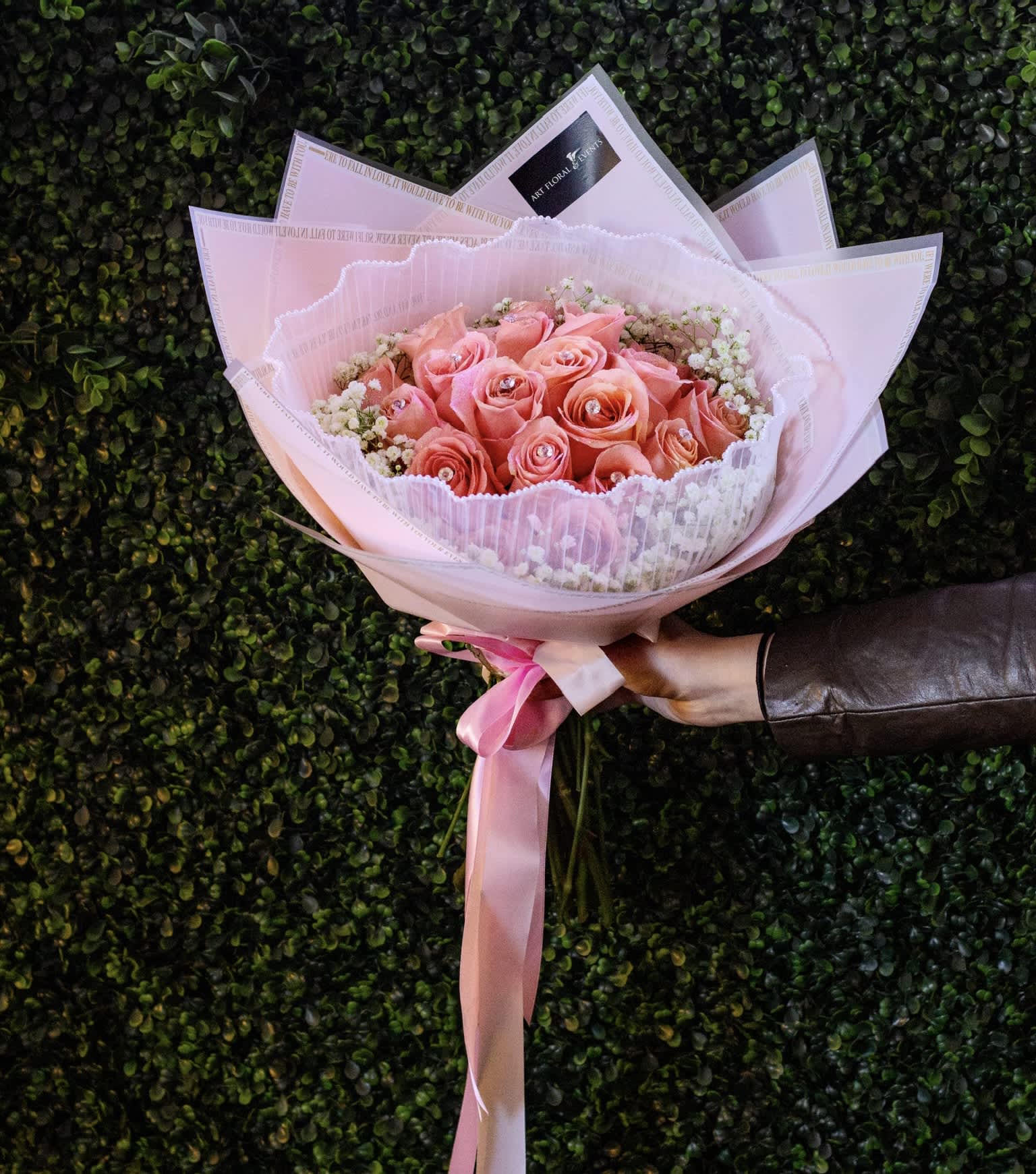 Pink and White Bliss - Order a pink and white bouquet this Valentines day wrapped beautifully with white pearl lace. . This bouquet includes 18 pink roses, and a bountiful of baby-breath with stunning crystals attached to each rose.
