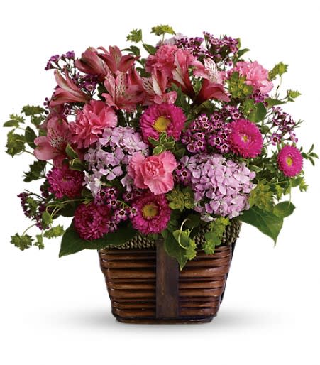 Country Fields - A mix of fresh flowers such as pink carnations, Matsumoto asters, Sweet William and alstroemeria is accented with greenery and delivered in a rustic basket. Orientation: All-Around 