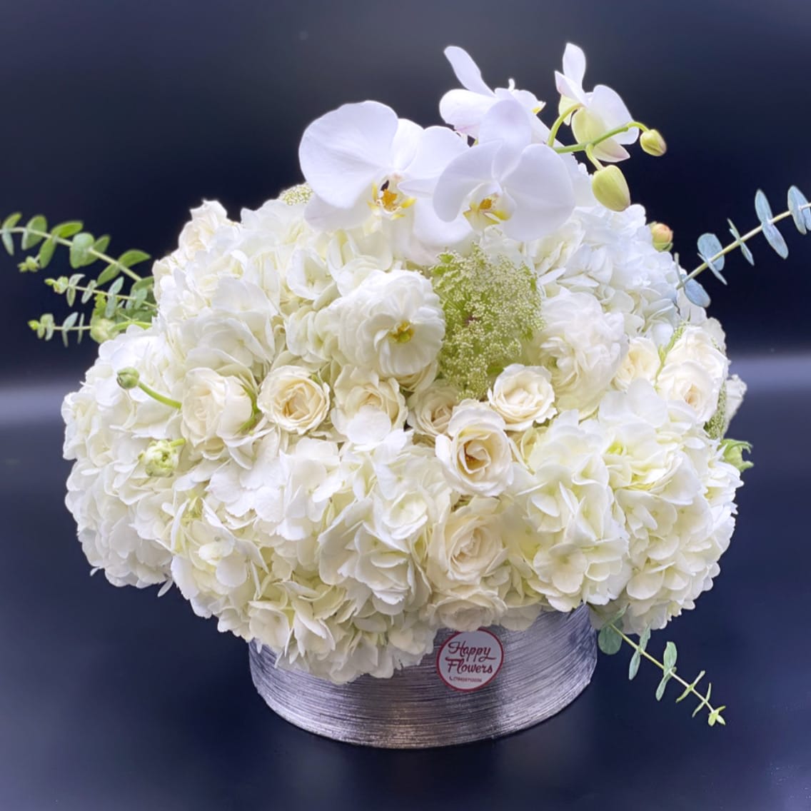 White flowers mix - white hydrangea and orchids in a vase