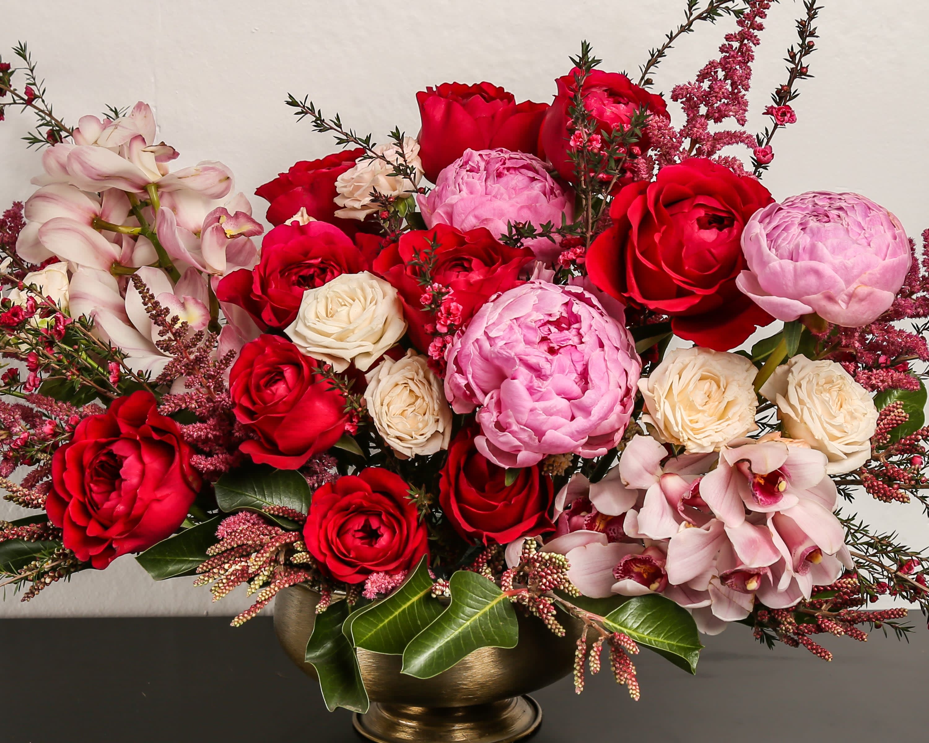 Impress - Composed of roses, spray roses, orchids, peonies, astilbe, variety of green.