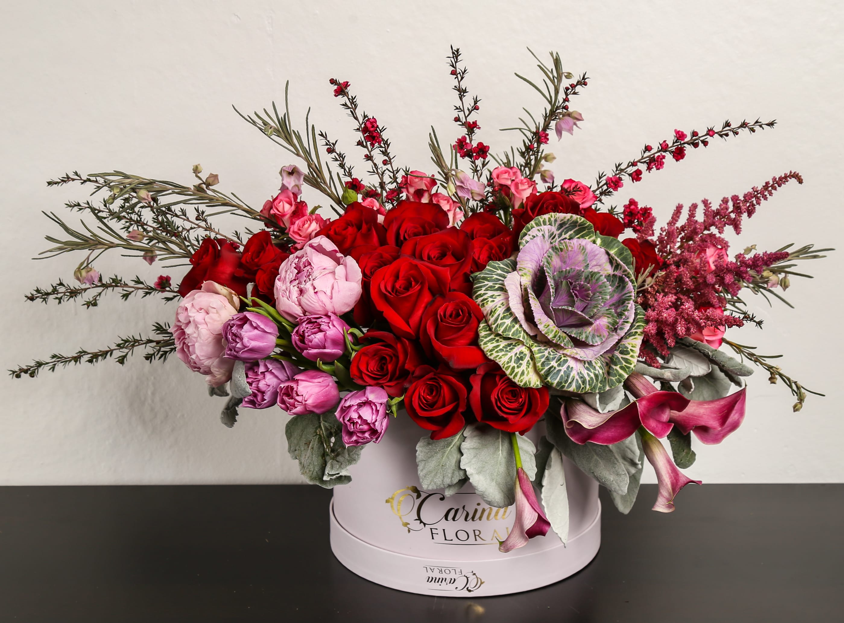Madly in Love Madly in Love - Composed of roses, tulips, peonies, kale, Cala lily, astilbe, variety of green.