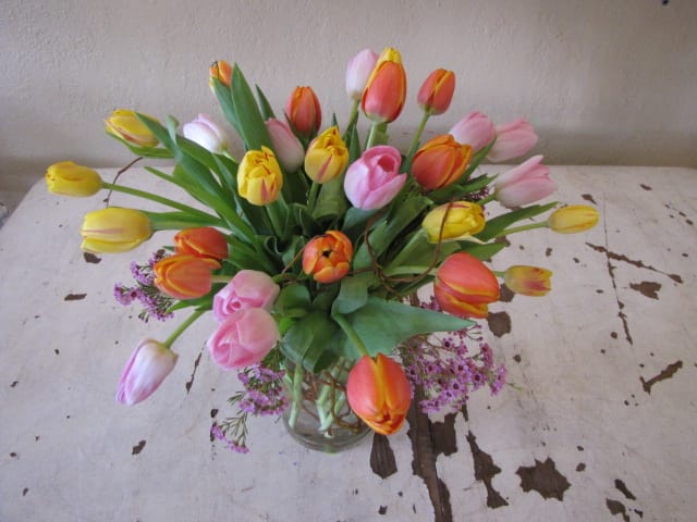 Tulips Mania Tulips Mania - 30 tulips in three different colors artfuly arranged in a clear vase.