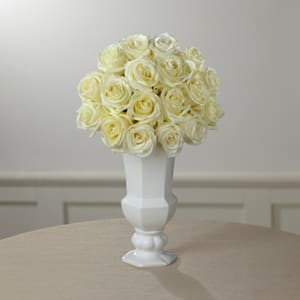 The FTD® Special Blessings™ Bouquet - Elegant simplicity defines this extraordinary floral tribute that beautifully expresses what’s in your heart at a time of profound sadness. An exquisite cloud of heavenly white roses, simply arranged by a local FTD artisan florist in a classic white ceramic urn vase, makes a stunning addition to a wake, funeral or graveside service. Its loveliness can provide much-appreciated and long-remembered comfort when sent to the family’s home.