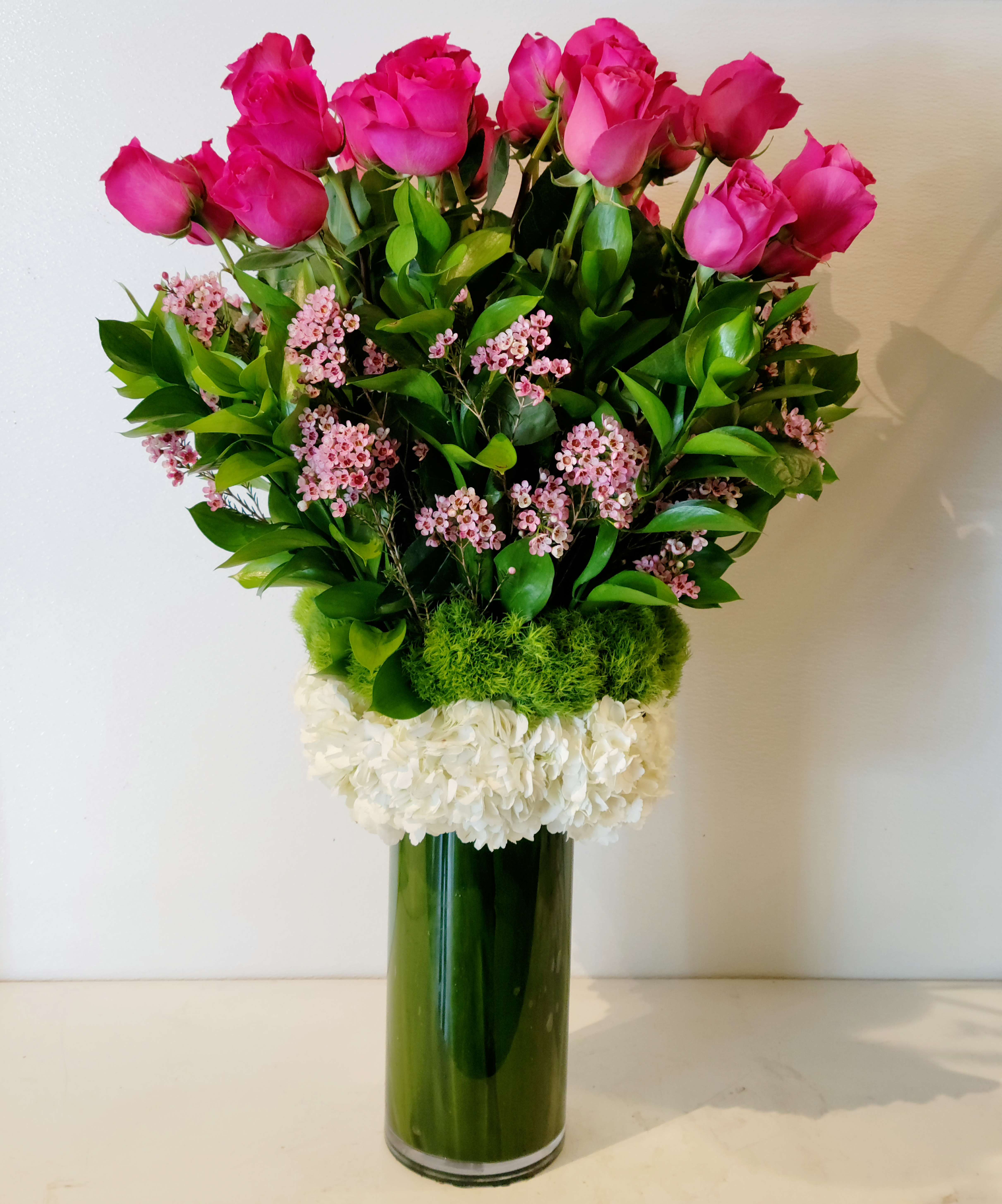 2dz. Long Stem Pink - 2 dozen long stem hot pink roses arranged in a vase with a touch of filler and greenery.