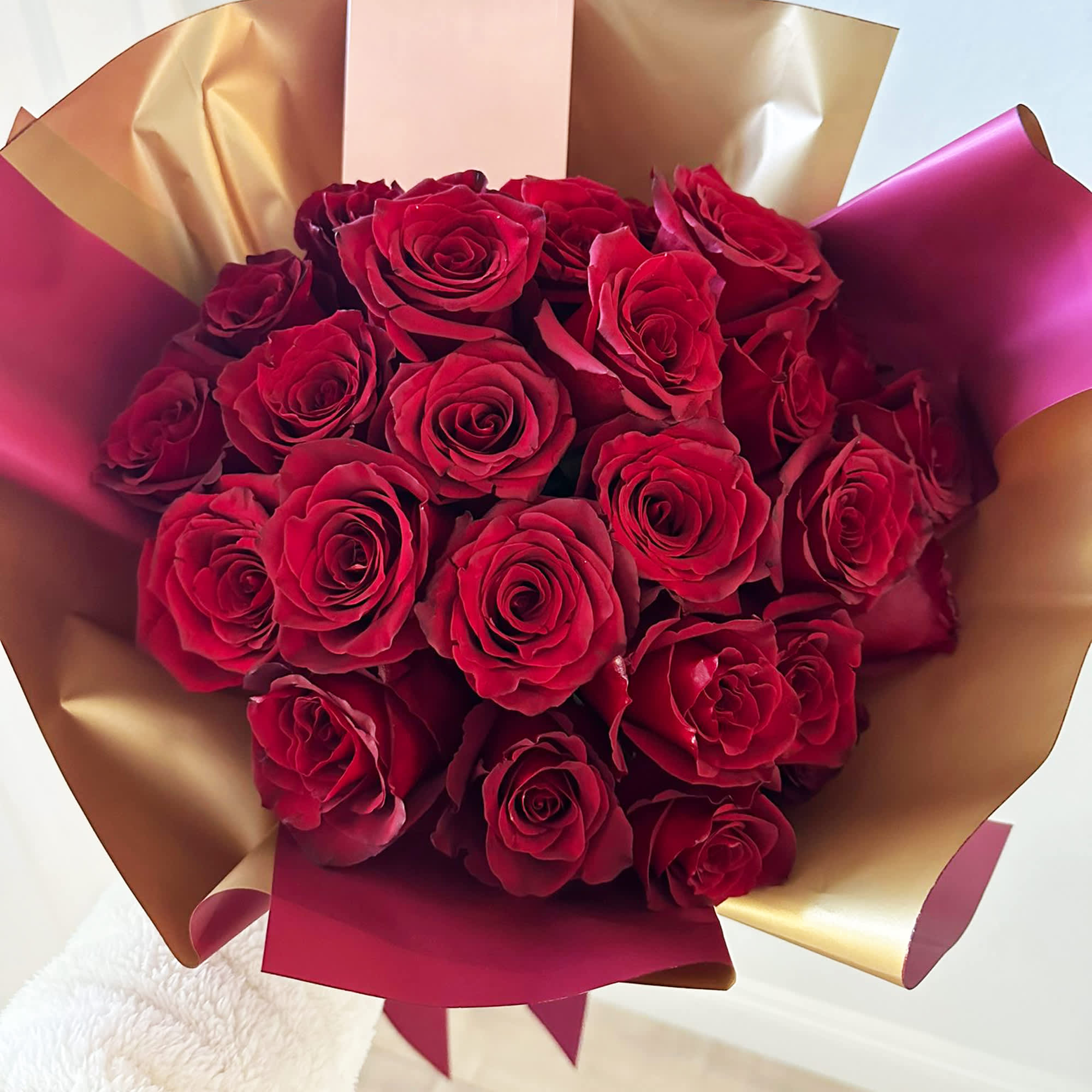 The Classic - A bouquet of red roses is a timeless symbol of love, passion, and romance. The bouquet is carefully wrapped with a combination of golden and red paper, enhancing its allure and creating a striking presentation. Whether presented as a romantic gesture or a heartfelt expression of affection, a bouquet of red roses captivates with its classic beauty and timeless charm.