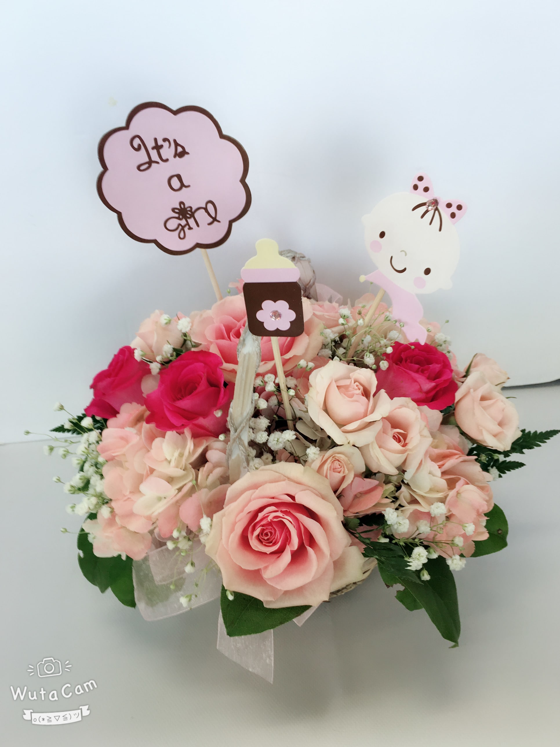 She's lovely basket bouquet - Thank heaven for little girls! And for adorable arrangements like this one! Perfect for new moms, new babies and girly-girls of all ages, this sweet basket of pink petals is sure to get a warm welcome!  Pretty pink hydrangea, roses and spray roses along with baby breath are delivered in a charming white basket that's all wrapped up with a pink bow. Say hello to beauty, cutie! Orientation: All-Around Size: 12&quot;H x 12&quot;W 