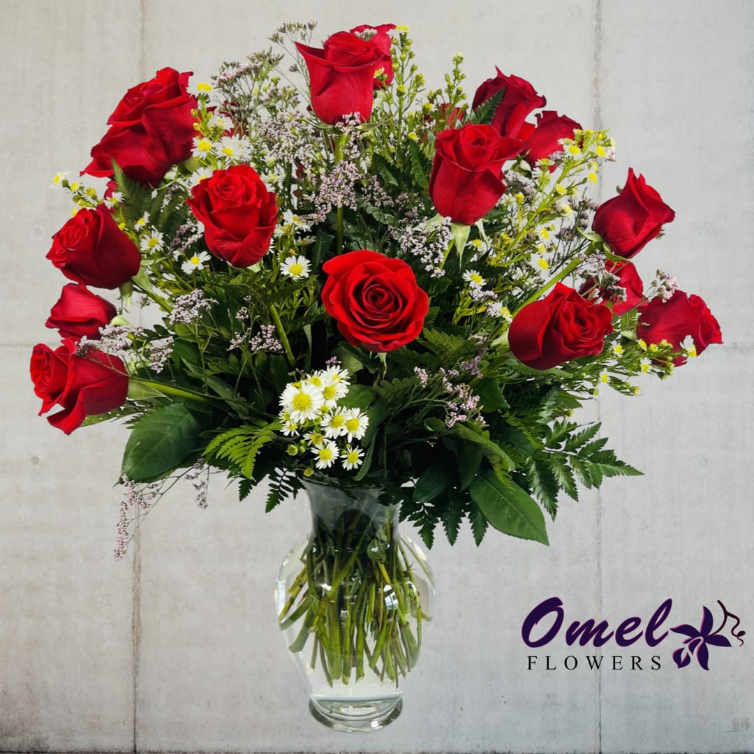 Two Dozen Premium Long Stem Red Roses - Express Your Love with Stunning 24-Inch Premium Long-Stemmed Red Roses  Our elegant arrangement features rich red roses, carefully selected for their premium quality and long stems. The stunning blooms are presented in a clear glass pedestal vase, adding an extra touch of sophistication to this timeless display of love. With each petal representing a beat of your heart, these roses will help to bind your hearts together and create a lasting connection that will endure for years to come.