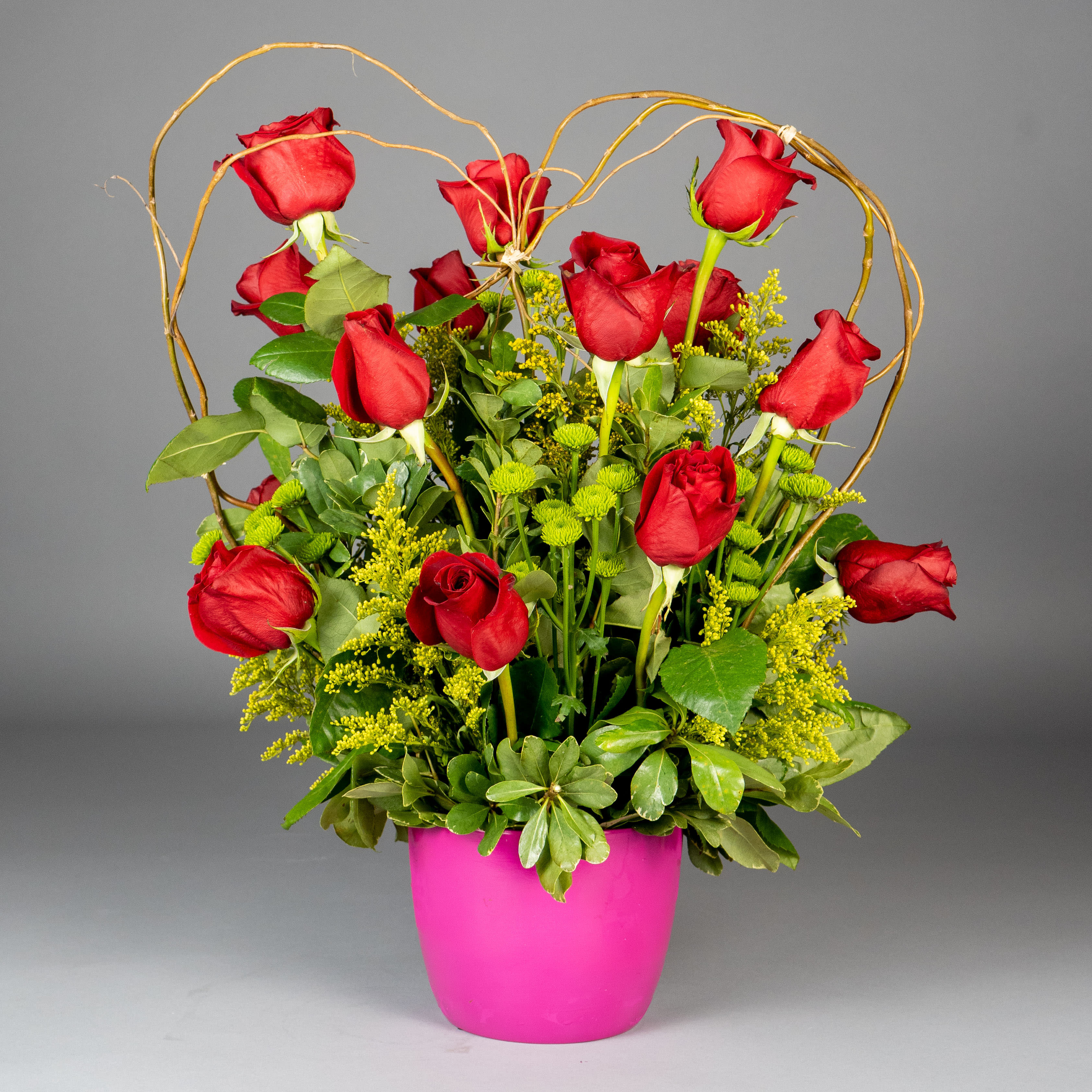 Passion Heart - Express your love with this stunning arrangement of long-stemmed roses artistically arranged in the shape of a heart and accented with curly willow. Standing tall in a modern container, this breathtaking design is sure to impress your special someone.