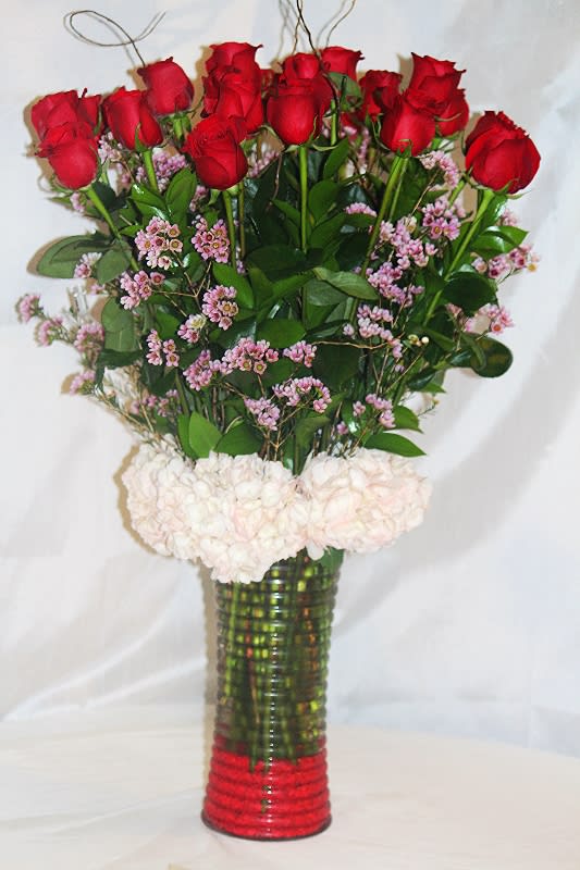 2 DZ. Red Roses - 2 dz. red roses arranged in a clear glass vase with hydrangeas and wax flower