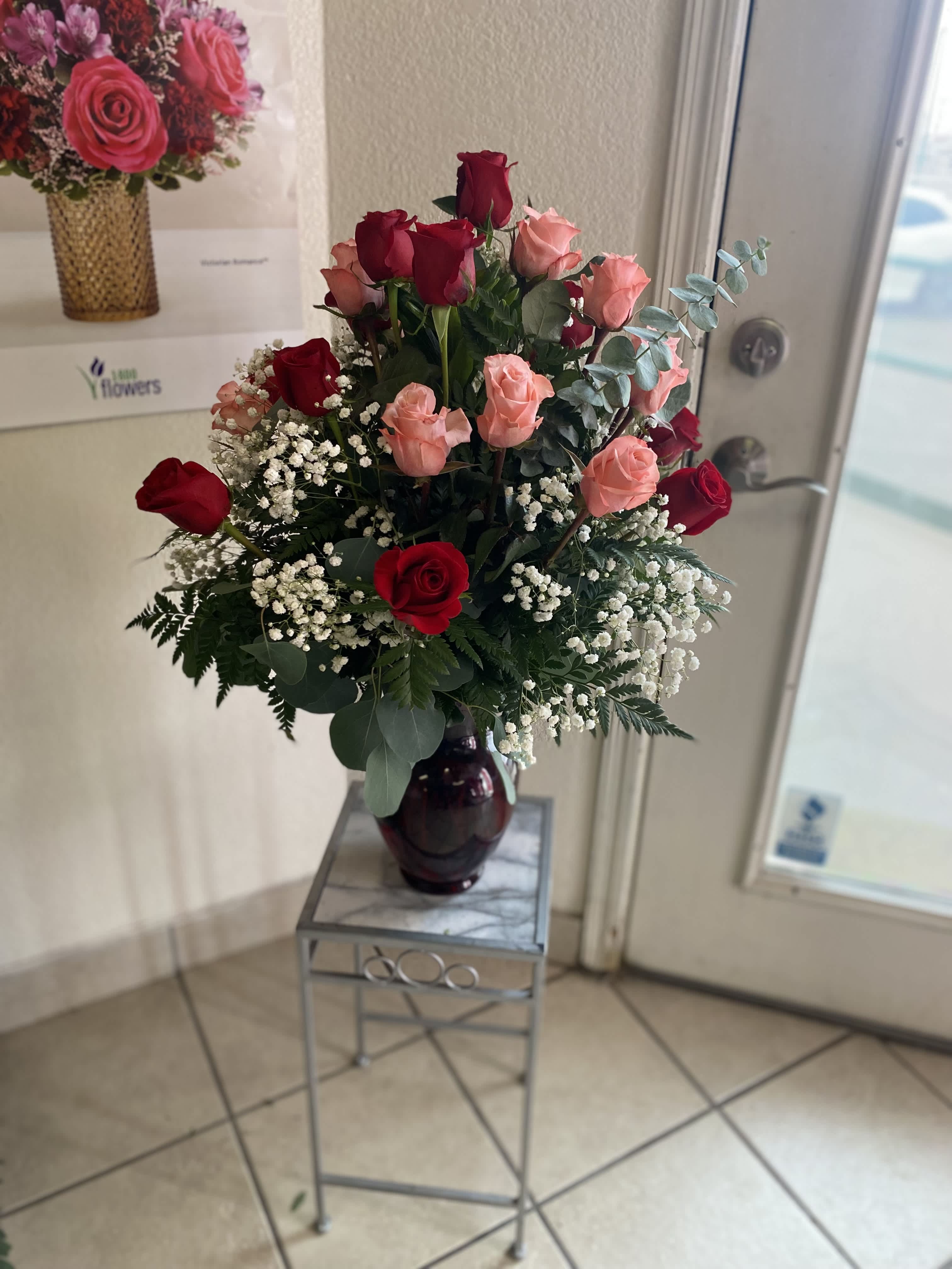 24 Red and Pink Rose Arrangement - 24 red roses beautifully arranged in a clear vase. A