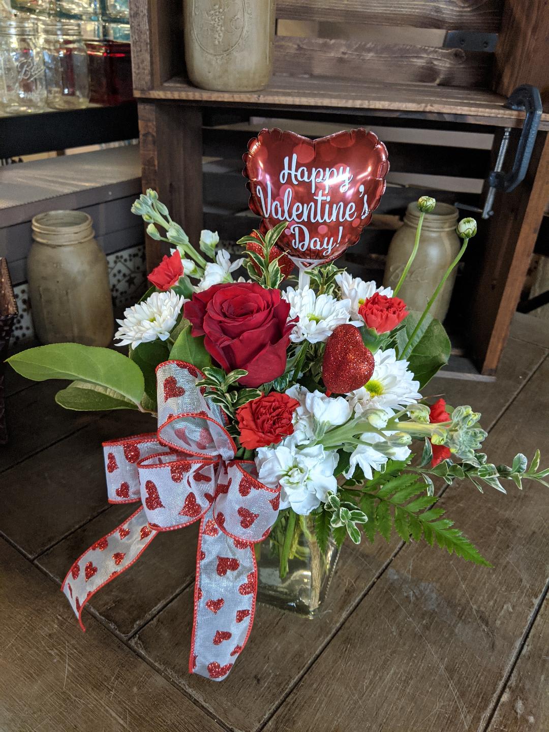 Radiant Hearts Bouquet Custom Designed by Cold Spring Floral Radiant Hearts Bouquet Custom Designed by Cold Spring Floral - Radiant Hearts Bouquet is filled with Valentines Day Celebration! Hand Designed by our Staff in a clear glass vase with a Beautiful Red Rose, White Stock, White Mums, Red Miniature Carnations, and a 4 inch Valentines Day Balloon and Ribbon. All Flowers, Containers, Vases accents such as ribbons, Balloons and picks are subject to substitution based on availability and will be hand picked by our staff to ensure beauty and freshness.