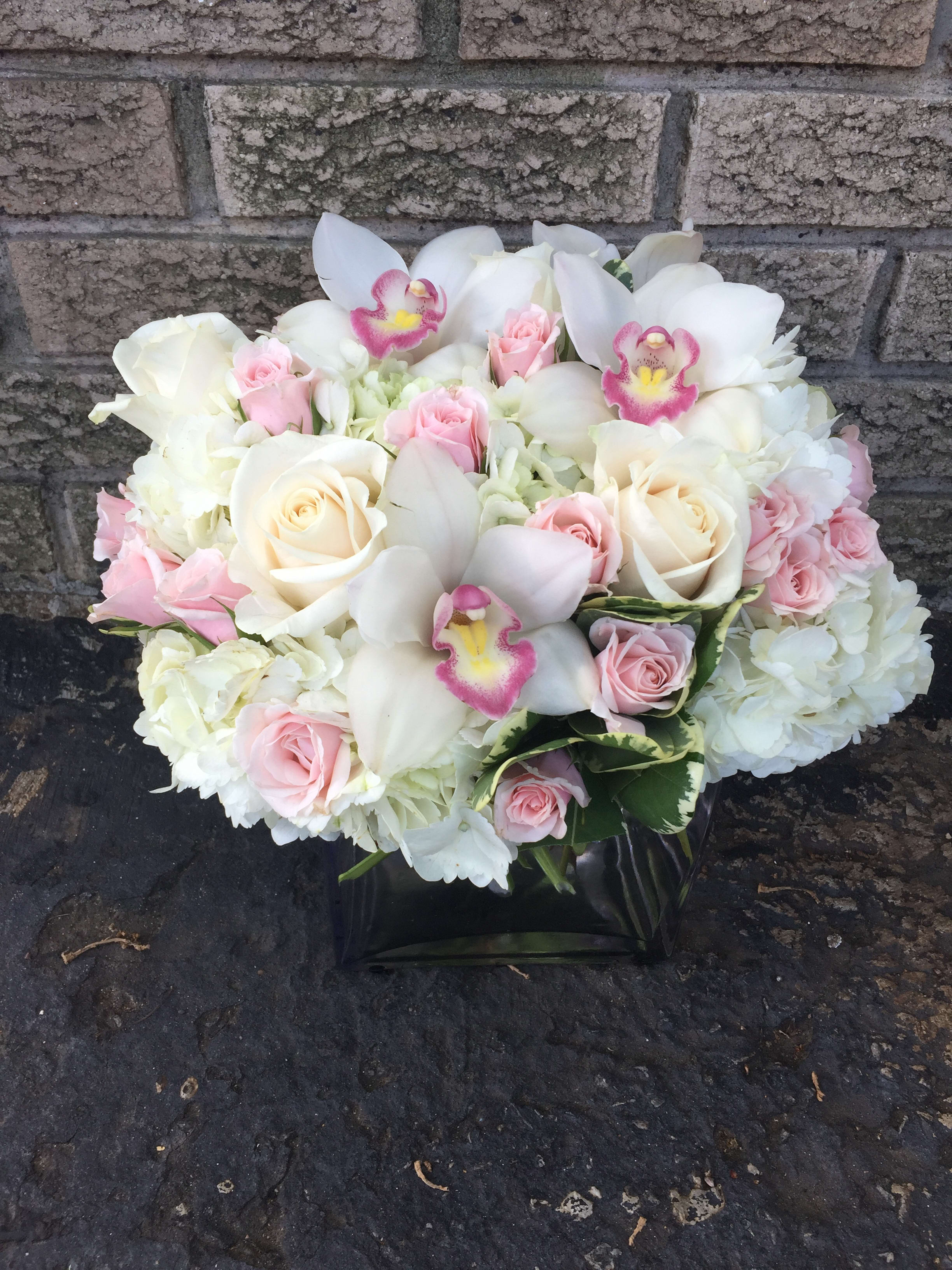 With Love  - Cube vase with white hydrangea, White cymbidium orchids light pink roses. 