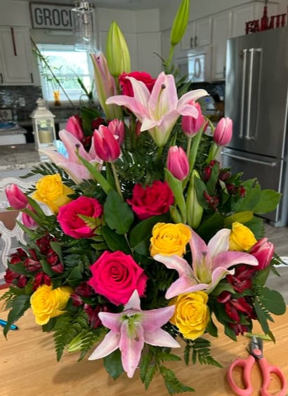 Vibrant Harmony Vibrant Harmony - The bouquet is a rich tapestry of colors, featuring prominently pink and white Asiatic lilies whose large, open blooms and unopened buds provide a dramatic touch with their soft, pastel hues.