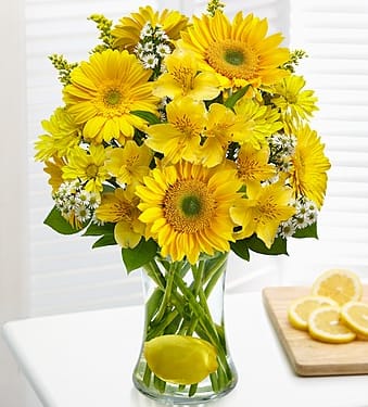 Yellow Cheer - For everyone out there who likes to look on the bright side, this bouquet’s for you! Cheerful yellow Gerbera daisies, alstroemeria, daisy poms and more are hand-designed by our expert florists in a glass gathering vase with a real lemon for a truly original twist that keeps the smiles coming.