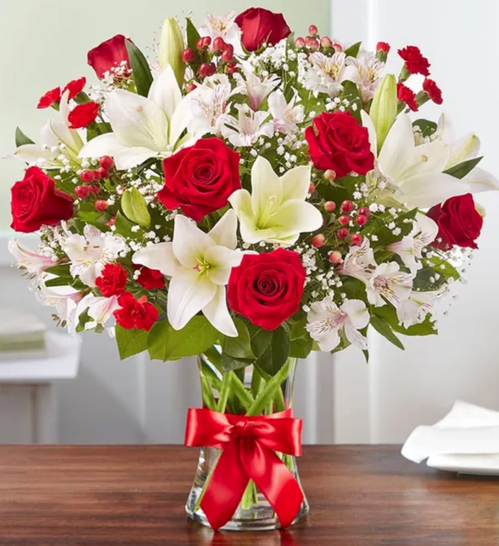 Gem - That feeling of bliss, captured in a bouquet. Inspired by the beauty of the European countryside, our best seller brings together radiant roses and lush lilies in a glass vase wrapped in red ribbon. Whatever your reason for reaching out, it’s a gift that delivers on delight.