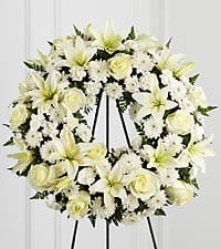 TREASURED TRIBUTE WREATH TREASURED TRIBUTE WREATH - Deluxe is pictured. The Treasured Tribute Wreath offers peaceful wishes of heartfelt sympathy with each delicate bloom.