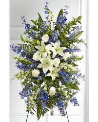 Faithfulness Standing Spray - Blue and white flowers shares a tribute that words cannot express. Standing Spray is a grand gesture to express kindness and solace to a loved one while they are remembering the life they cherished so much. 
