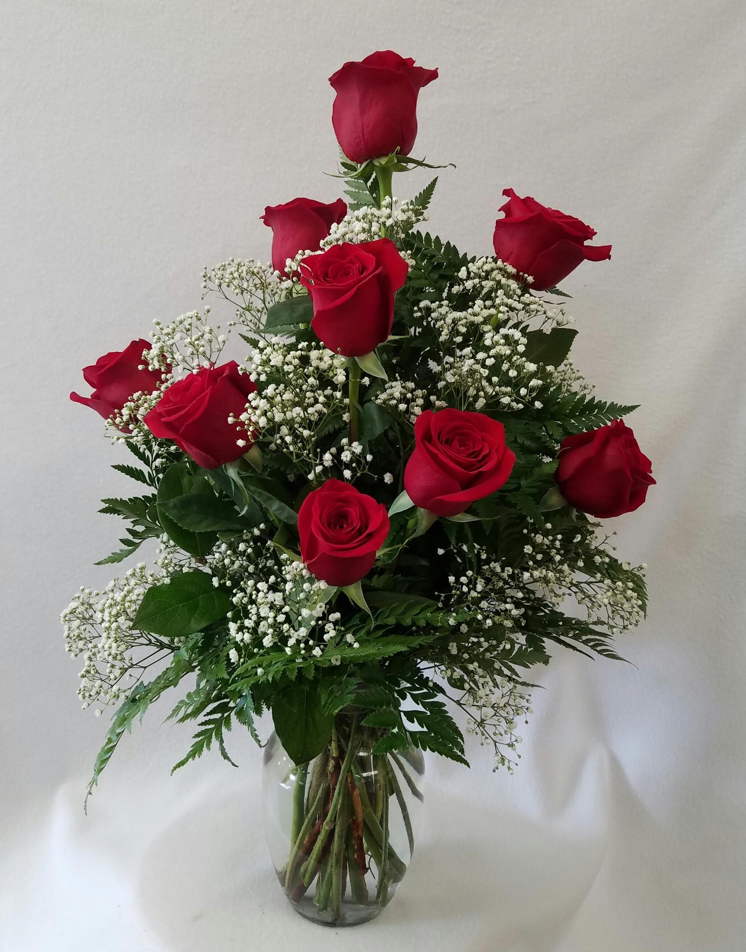  Dozen Red Roses with Filler - 12 red roses with baby''s breath (or other filler) in a clear glass vase. Deluxe: 18 roses.  Premium:  24 roses  Also available in white, yellow, orange, peach/pink, and many bi-colors. Please call to inquire about what is available! 