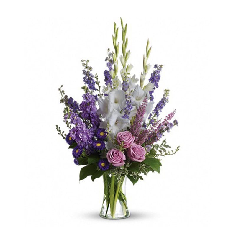  Joyful Memory - Lavender and white sympathy flowers make a grand statement in this joyful bouquet. Cherish your memories with this lasting remembrance of lavender larkspur and roses, deep purple asters, pure white gladioli and the softest pink heather.  A classic assortment of flowers such as lavender larkspur, stock and roses, plus purple asters, white gladioli and pink heather.      Orientation: One-SideD 