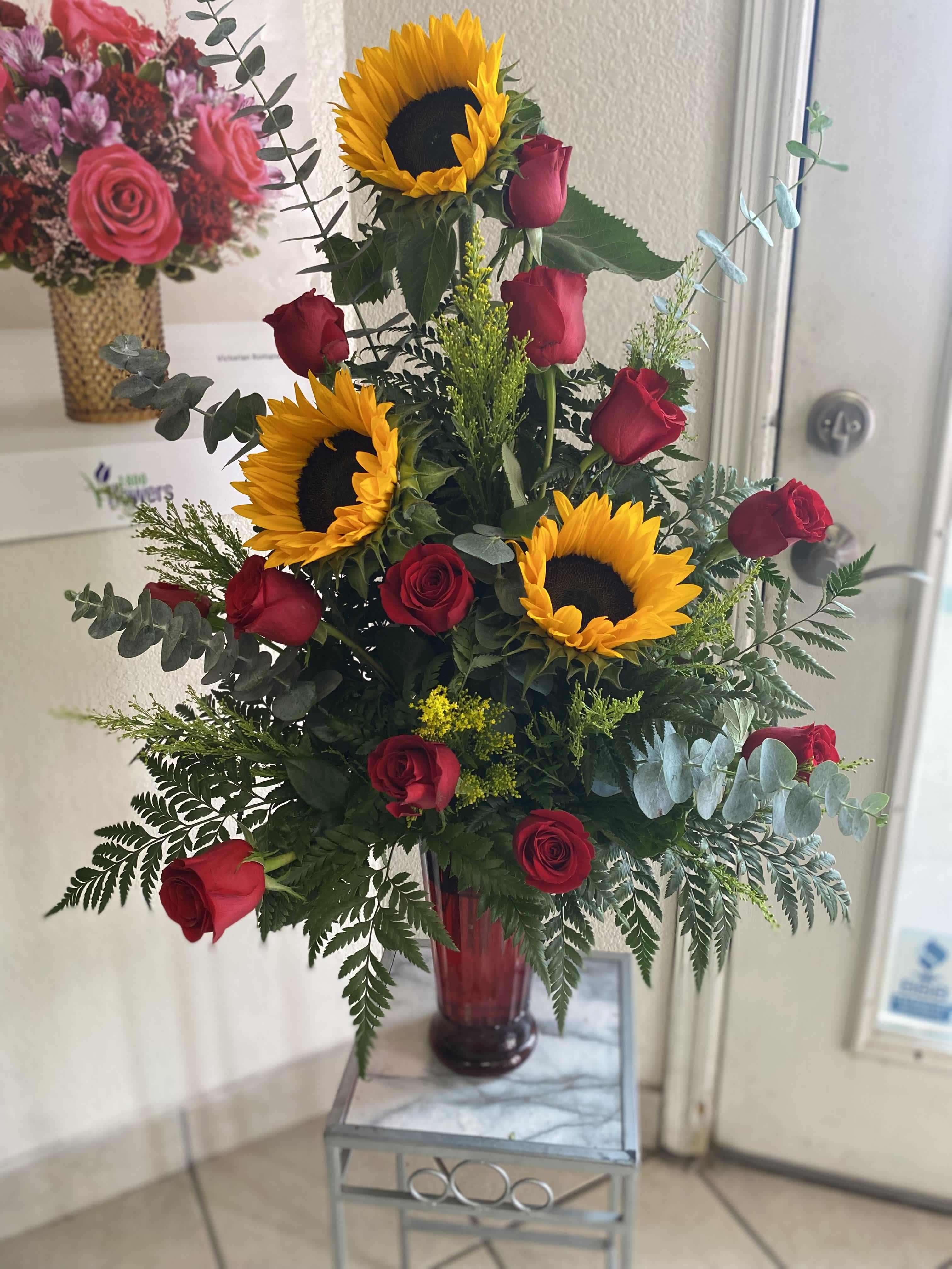 Sunflowers and Roses Sunflowers and Roses - A beautiful arrangement with sunflowers and a dozen red roses in a vase.