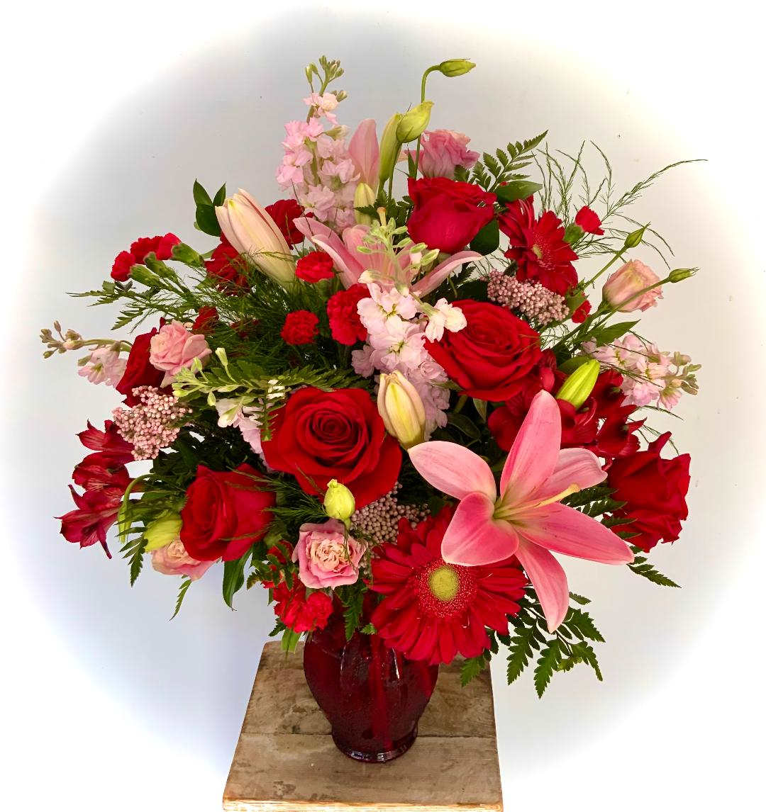 Loyal Love Premium Loyal Love Premium - Half a dozen brilliant red roses with Pink Lilies, Red Gerbera Daisies, Pink Stock, Pink Rice Flower, Pink Lisianthus, and more!