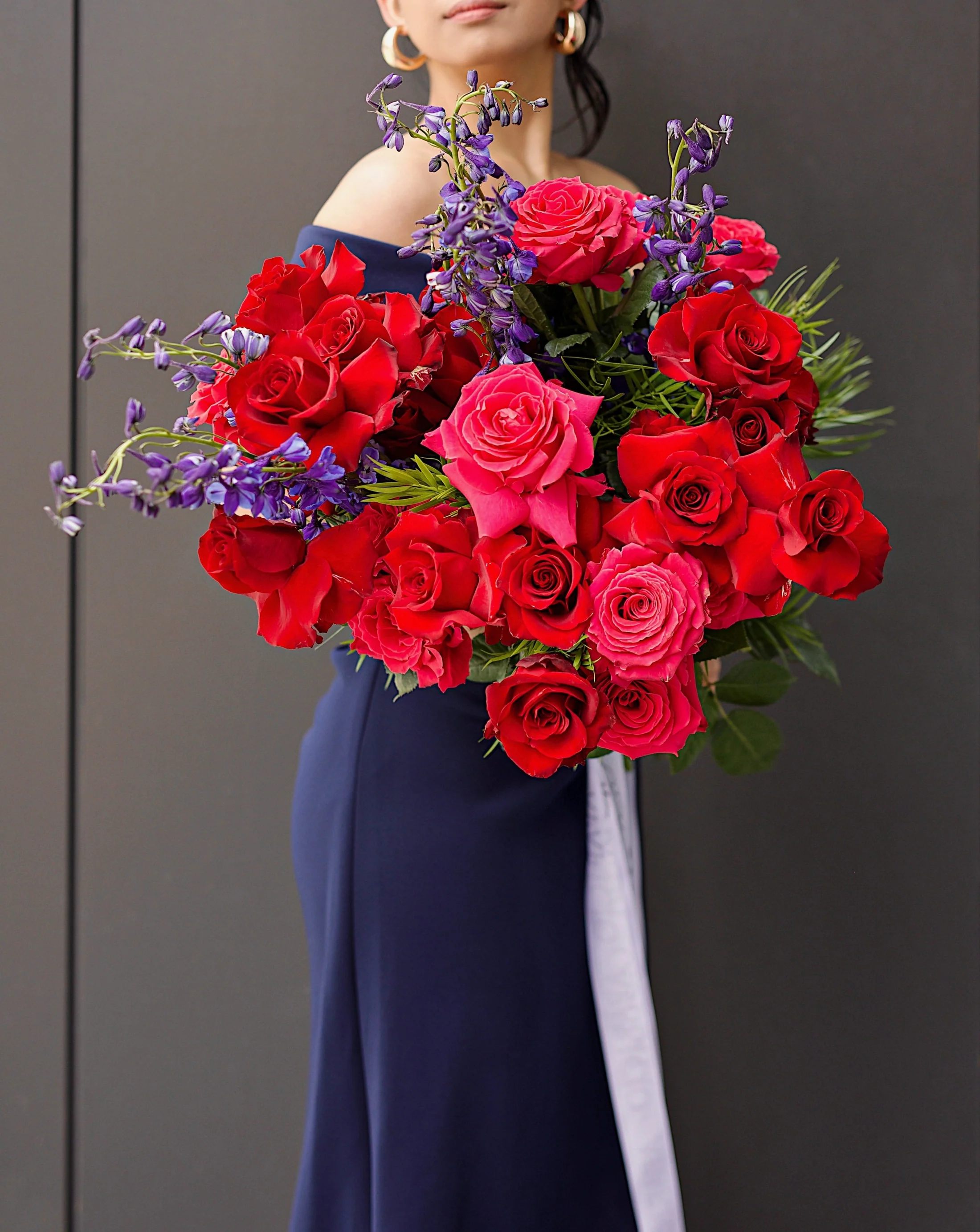 Designer Bouquet &quot;Passion in Madrid&quot; - Our &quot;Passion in Madrid&quot; designer bouquet is a bold and passionate floral arrangement that evokes the vibrant energy and excitement of the Spanish capital. This stunning bouquet features the deep red tones of Explorer Roses and the soft pink hues of Full Monty Roses, expertly accented with the striking blue petals of Delphinium. Our skilled florists expertly arrange this bouquet to create a mesmerizing display of colors and textures that captures the essence of Madrid's passion and intensity. The &quot;Passion in Madrid&quot; bouquet is the perfect gift to celebrate any special occasion or to simply brighten up a loved one's day with a touch of luxury and style. Let the beauty and elegance of this bouquet transport you to the vibrant city of Madrid and ignite a passionate spark in your heart.  Medium - 25 stems (shown in pictures) Large - 50 stems Extra Large - 75 stems
