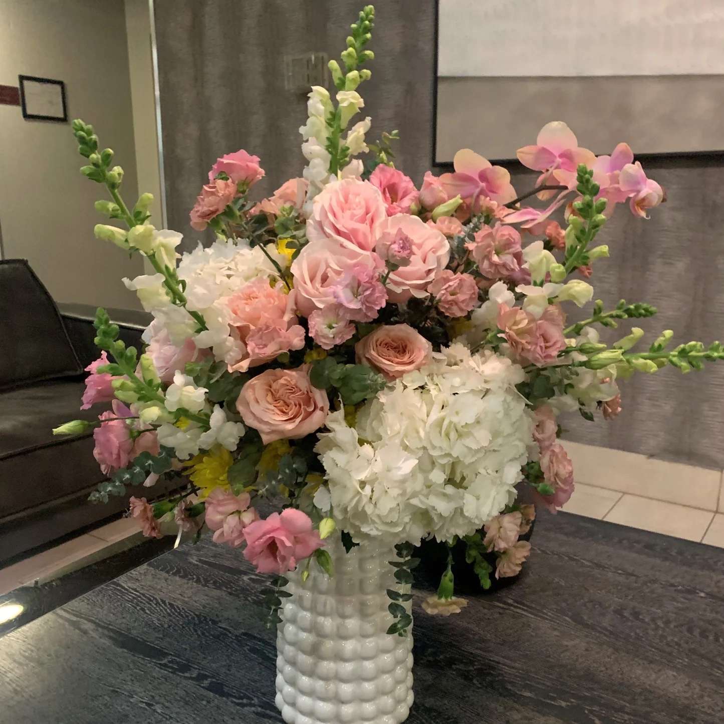 Vase Arrangement &quot;Morning in Miami&quot; - Our &quot;Morning in Miami&quot; vase floral arrangement is a stunning mix of exotic orchids, classic roses, tall snapdragons, delicate hydrangea, and sweet carnations. This beautiful arrangement is designed to add a burst of vibrant color and elegance to any space. With a harmonious blend of pink, white, and purple blooms, this vase arrangement is expertly crafted and arranged in a stunning vase, making it a perfect centerpiece for your home or event. Whether you're looking to add a touch of beauty to your office, home, or event, our &quot;Morning in Miami&quot; vase floral arrangement is the perfect choice. Order yours today and enjoy the beauty of these exquisite flowers.