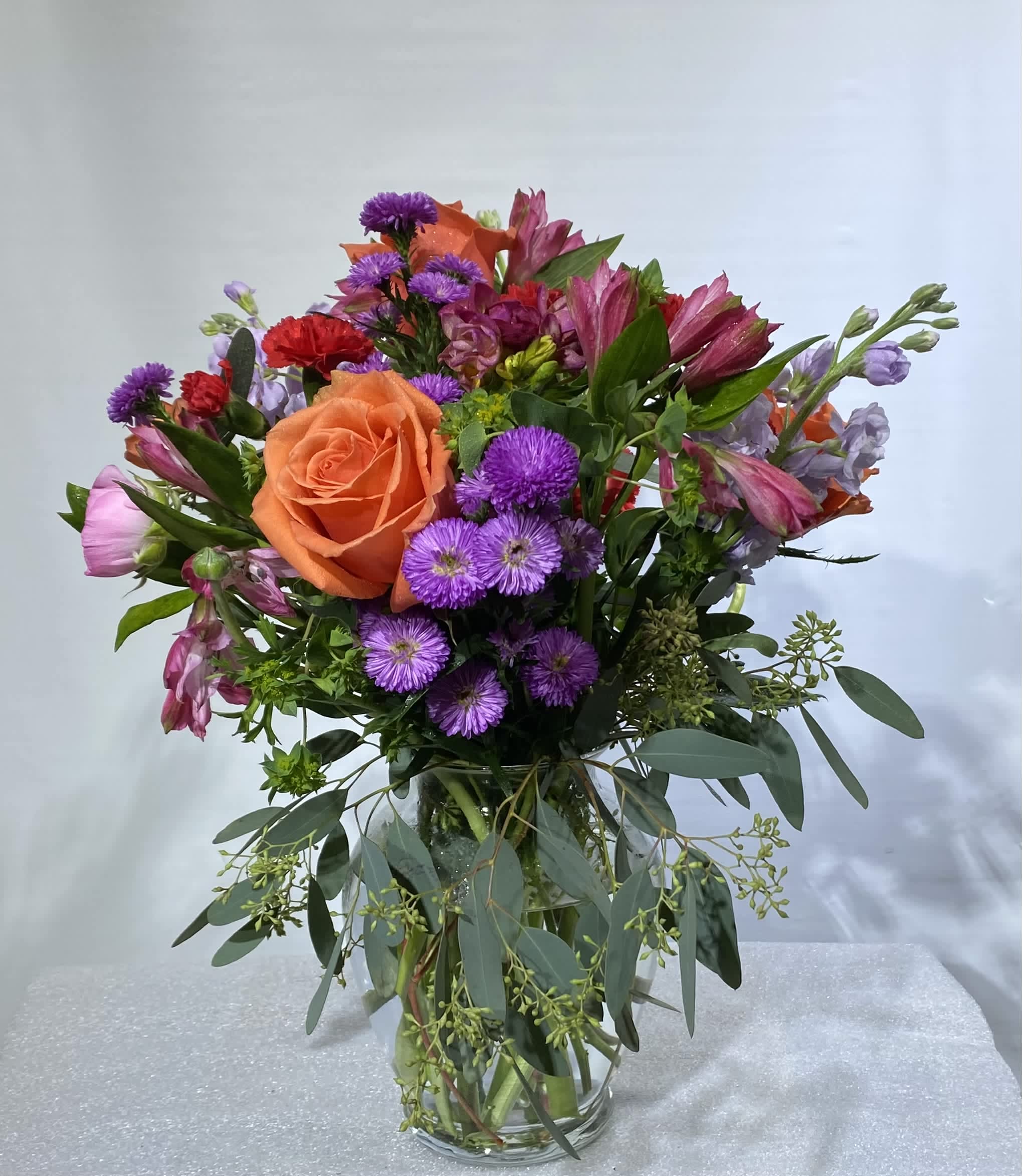Bouquet of many colors  - Celebrate good times with this lively bouquet. The arrangement includes roses, alstroemeria, stock, aster, and other seasonal blooms.  This is the perfect gift for Mother's Day, Birthday, or Just Because. APPROXIMATE DIMENSIONS: 12&quot; D x 15&quot;H