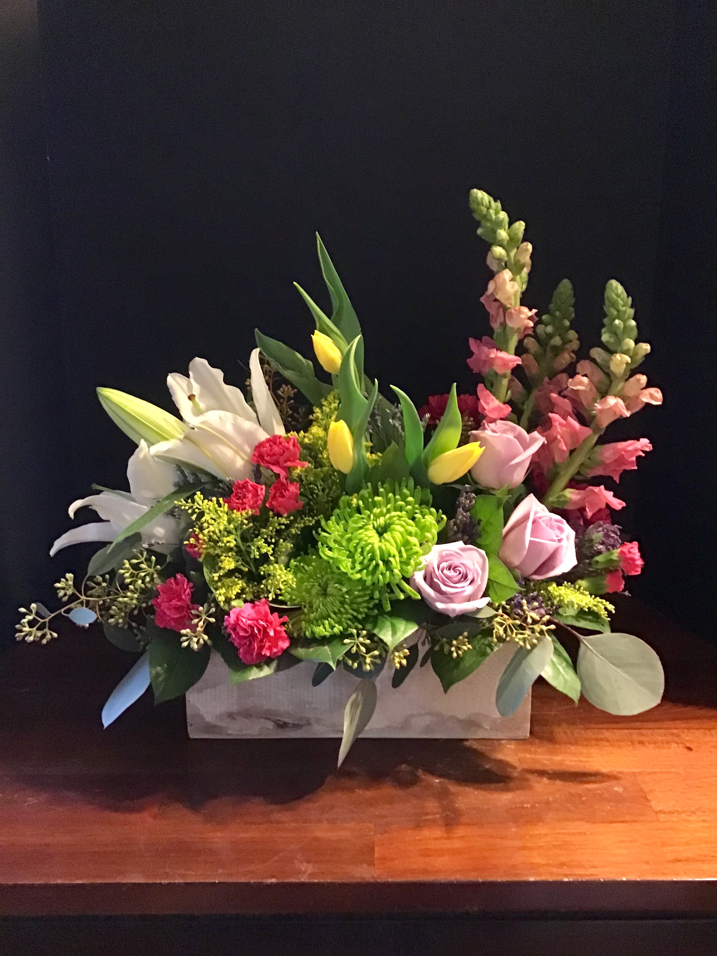 Breath of Spring  - An assortment of spring flowers, snaps, roses, tulips, spidermums, lilies and carnations with filler in a shabby chic box. Colors may be substituted 
