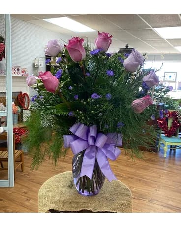 Lavender Lush - A dozen lavender and purple roses will greenery and lavender bow.