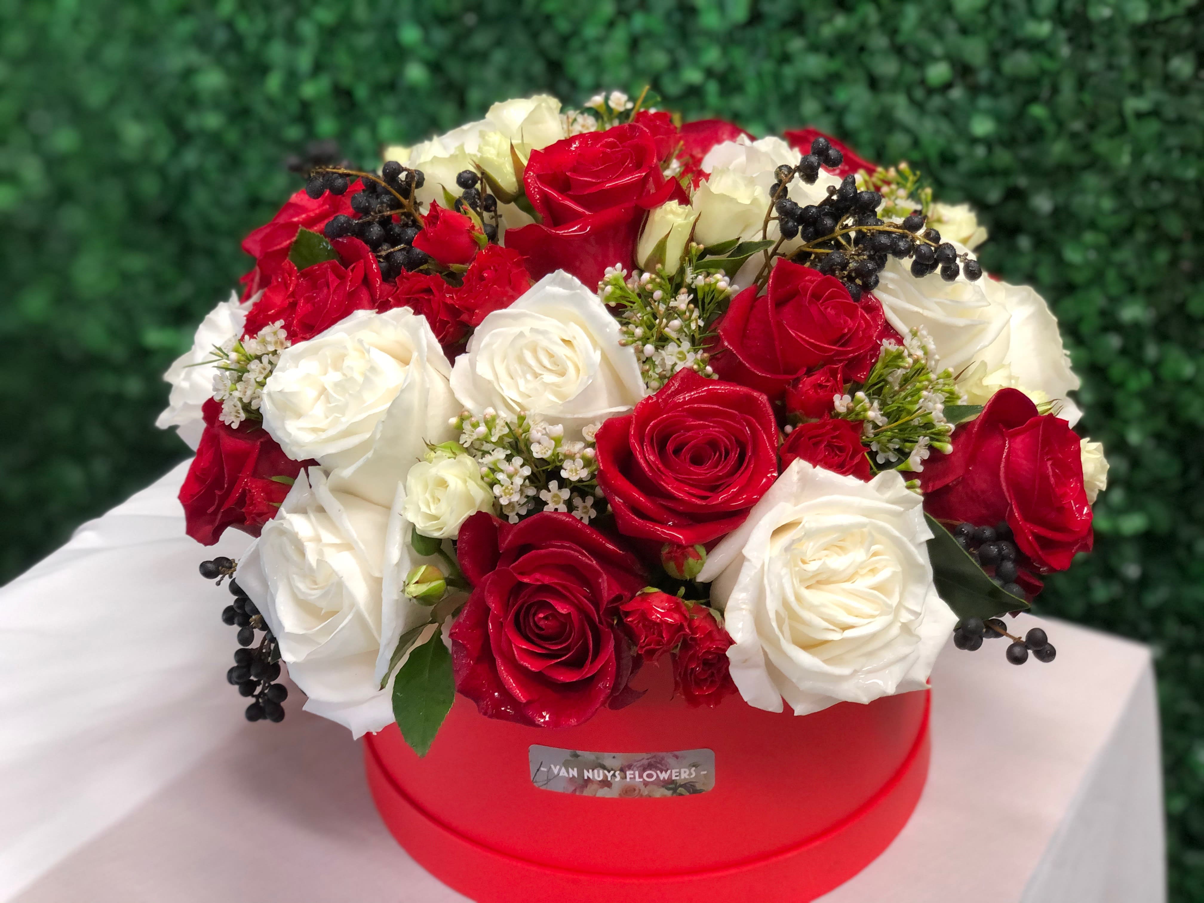 JUST YOU AND ME  - A BEAUTUFUL BLEND OF RED AND WHITE ROSES IN A FLORAL BOX MAKES FOR A STUNNING FLORAL. ROSES,SPRAY ROSE, WAX FLOWER, VIBURNUM BERRY