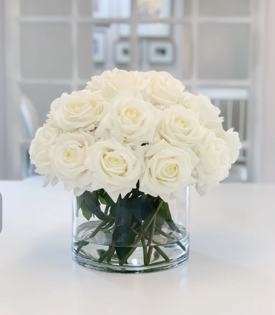 Bianca  - 24  stems of white roses placed in a clear vase .if you prefer a different color contact us .