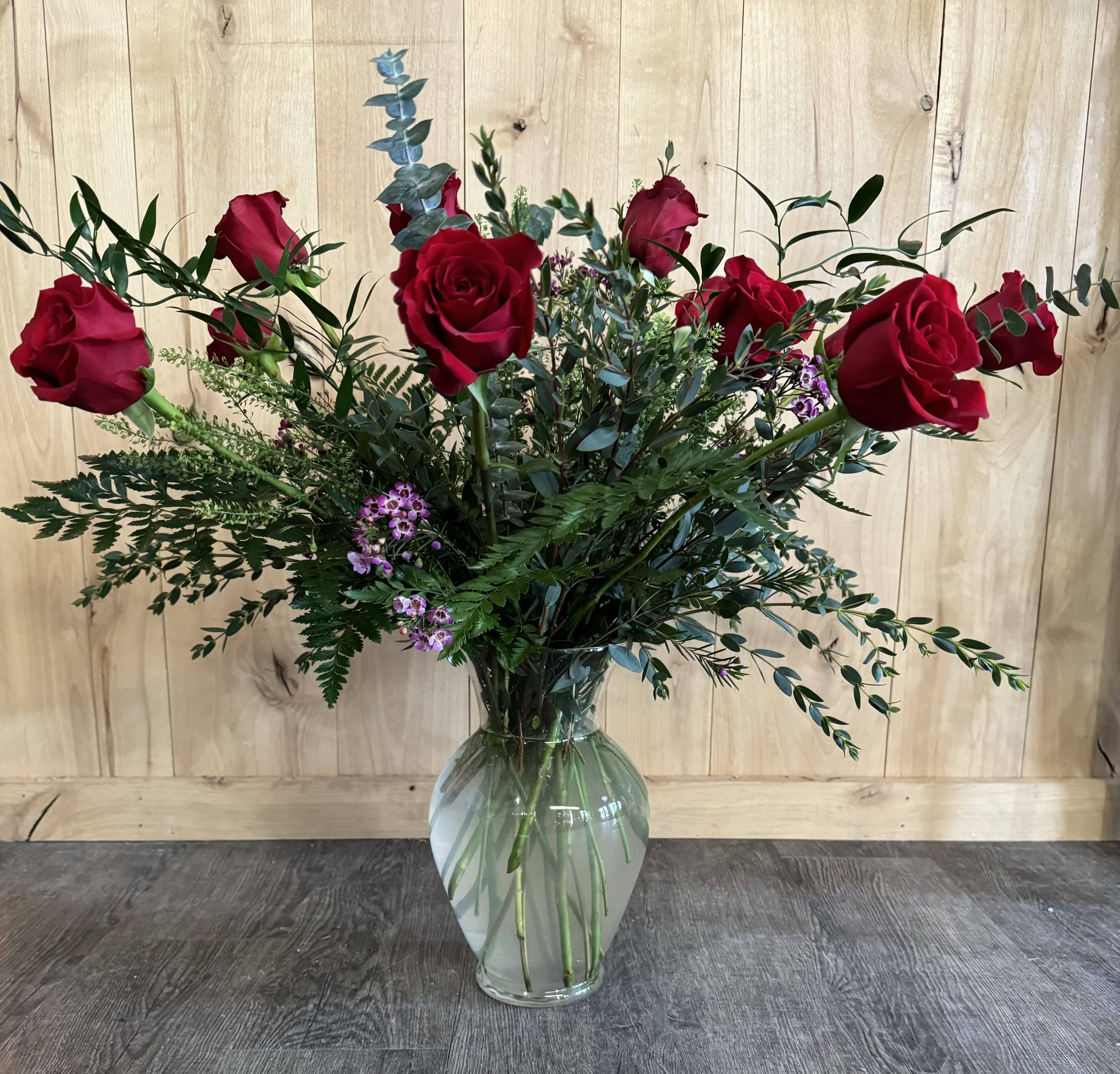 Dozen Roses with Fillers and Greens (any color) - Enjoy a large and full vase arrangement with gorgeous, fillers greens and a dozen red roses or another color based on availability