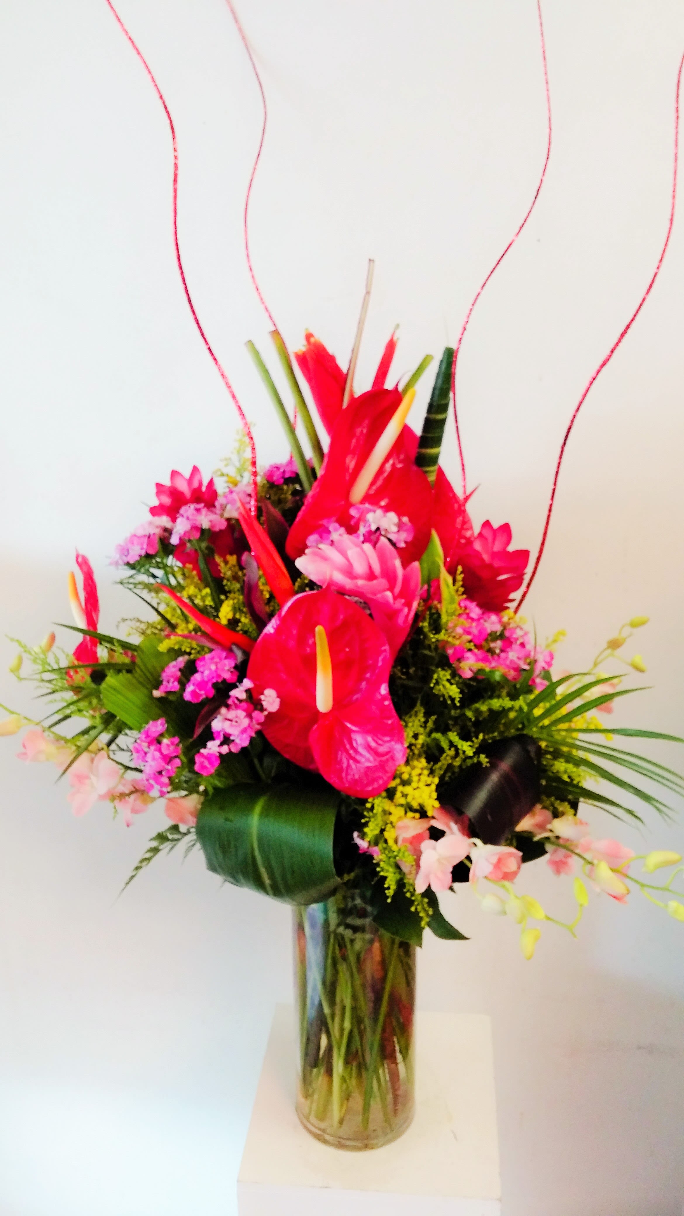 Tropical Design with Orchids - 5&quot; x 12&quot; cylinder vase with an assortment of tropical flowers and dendrobium orchids.