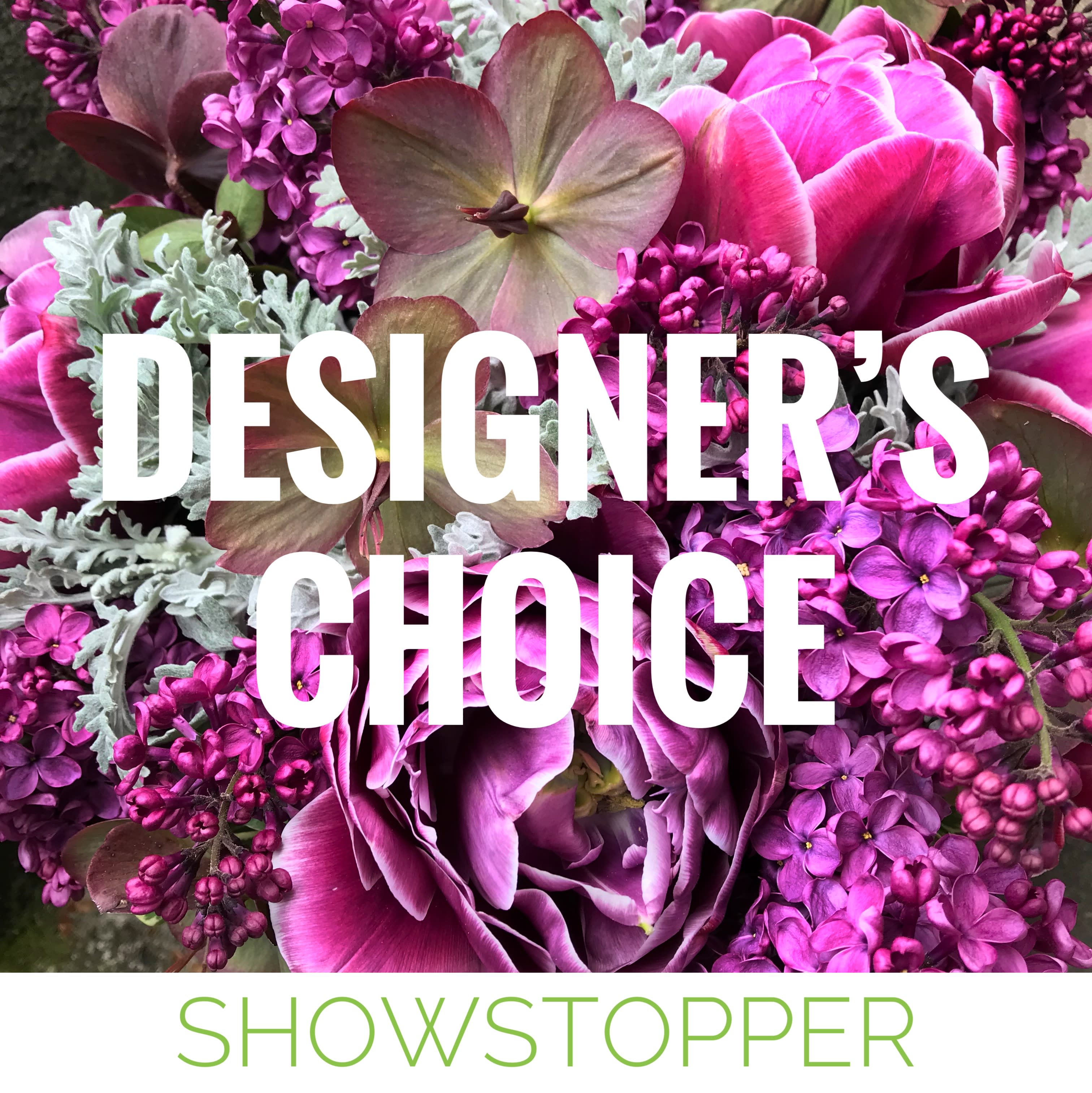 Showstopping Arrangement - A beautiful and dramatic floral arrangement guaranteed to steal the show! A designer's choice arrangement consists of seasonal blooms arranged to value with the occasion in mind. Every week we work with a new our color palette so we have a constantly changing variety of flowers to work with. The freshest seasonal blooms will be used to create your arrangement. If you have special requests, please call us or use our custom arrangements order form.  We are happy to accommodate you.  Photos are examples of past floral arrangements that we have done. Actual arrangements will vary with the season, our weekly color palette and the flowers that we have on hand.