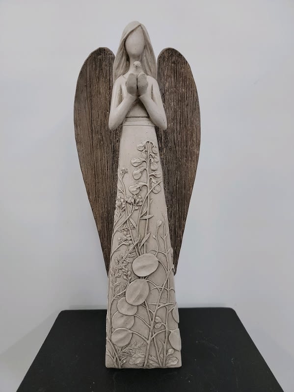 Wildflower Angel  - What a beauty this angel is.  She features a natural brown and grey tones with wildflowers etched on the her front.  Her hands are are folded together holding a dove.   Select the premium option and make your piece stand out with fresh flowers around its base.  This angel stands 13&quot; tall. 