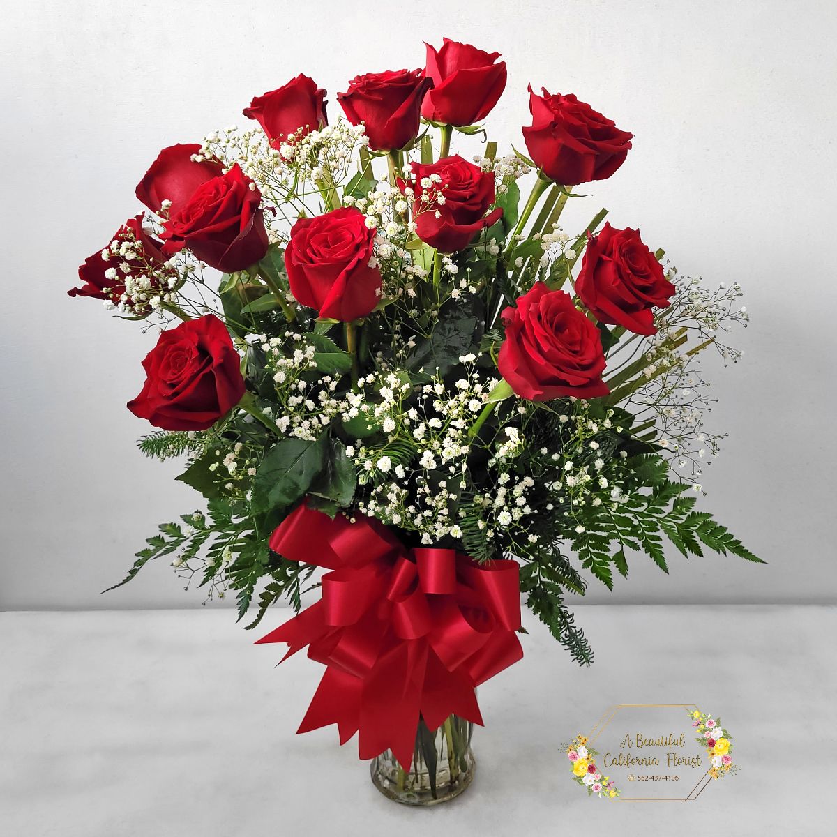 Premium Classic Romance - One Dz Red Roses with Babies Breath and Bow - Upgrade to our Premium Classic Romance - One (1) Dozen long stem RED roses, accented with lush greens. We enhance the arrangement with the addition of beautiful fluffy white babies breath. And as a finishing touch add a Red Satin Bow, to make it pop!   The perfect dozen for Valentine's Day, Love, Anniversary, or Just Because...   Approximate size: 28&quot; Tall x 22&quot; Wide   Red Roses, same day delivery from Long Beach's favorite flower shop, A Beautiful California Florist